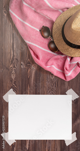 Summer Holiday Vacation Trip Mockup Concept Wallpaper with White Blank Free Space Paper Sheet with Adhesive Tape on Wooden Surface. File with Clipping Path.