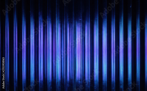 Neon Blue And Purple Corrugated Metal Wall Texture Background With Vertical Light Stripes For Modern Industrial Design Concept