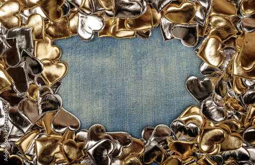 Golden and Silver Hearts on Denim Background with Central Empty Space