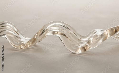 Clear glass wavy sculpture abstract art piece on neutral background for modern interior design and luxury home decor concepts