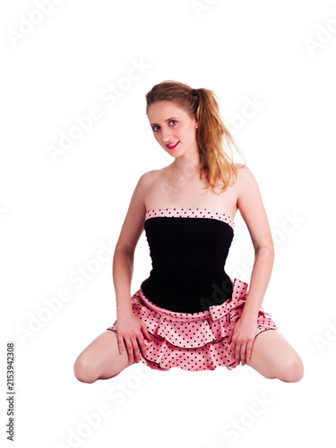 Young Caucasian Woman Kneeling In Pink And Black Dress