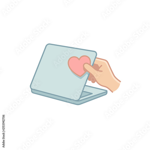 Hand applying heart sticker to laptop lid graphic