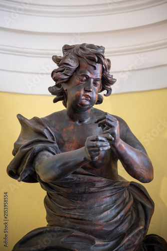 Photography Portrait with the expression of a wooden ebony angel statue.