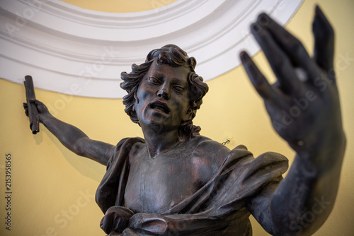 Photography Portrait with the expression of a wooden ebony angel statue.