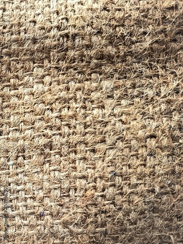 Close-up texture of woven coarse natural coconut fiber mat background