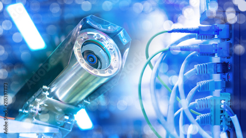 Security technology. Surveillance camera monitors network server cables for cybersecurity, data protection and digital infrastructure control.