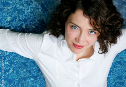 Attractive female model with bright blue eyes close up.	
