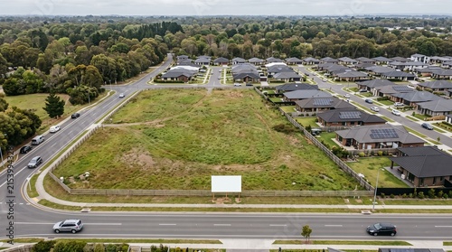 Aerial view of a vacant residential development lot with a blank billboard in a suburban neighborhood development residential property billboard construction neighborhood suburban