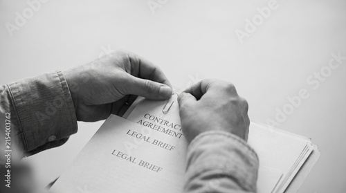 Close-up of hands passing a small folded note or paper slip, representing secret exchange, communication and confidential business information. Perfect for business and lifestyle stock photography.