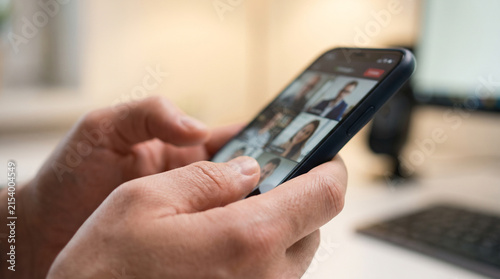 Hands photographing a scenic mountain landscape with a smartphone at sunset, representing travel photography, outdoor adventure and mobile technology use.