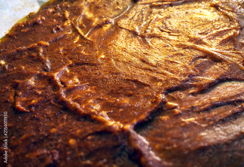 Closeup texture of perfectly cooked roasted meat with crispy browned surface ready to serve
