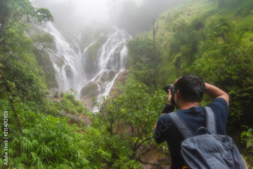 Hiker asian happy feeling freedom good and strong weight victorious facing on the natural mountain. Travel Concept
