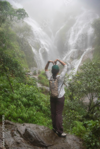 Hiker asian happy feeling freedom good and strong weight victorious facing on the natural mountain. Travel Concept