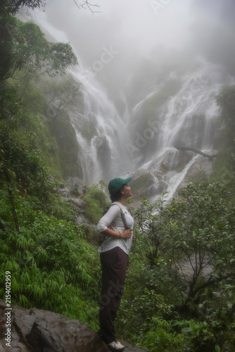 Hiker asian happy feeling freedom good and strong weight victorious facing on the natural mountain. Travel Concept