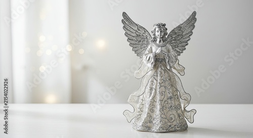 Elegant Silver Angel Figurine with White Dress on Bright Table