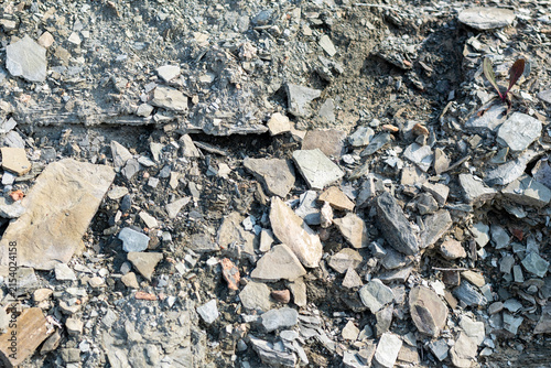 Fotografie Quebec, Canada, 28 July 2026 : Close-up view shows a textured surface of various rocks, gravel, and soil fragments