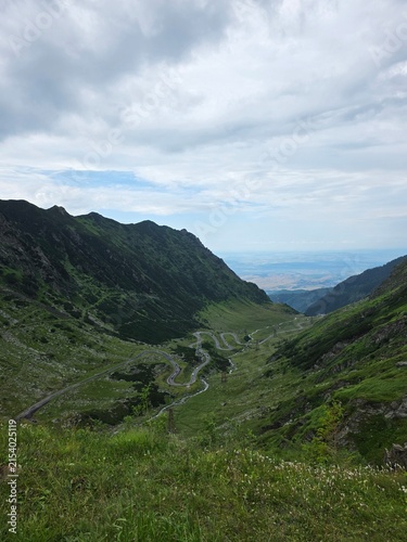 Winding Transfagarasan mountain highway twisting through a deep valley in Romania