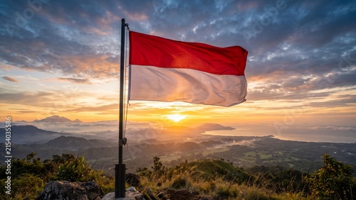 Indonesian flag waving on mountain top at golden sunrise,beautiful landscape view of mountains and sea,celebrating Indonesia Independence Day (17 August),patriotism, freedom,and national pride concept
