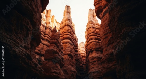 Towering Hoodoos and Narrow Slot Canyon Walls Bathed in Warm Sunlight