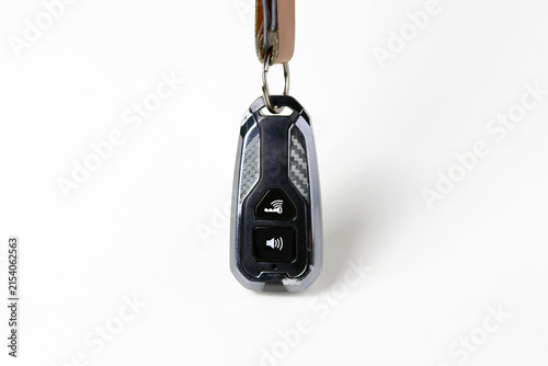 Close-up of a black electronic car key fob hanging from a keychain