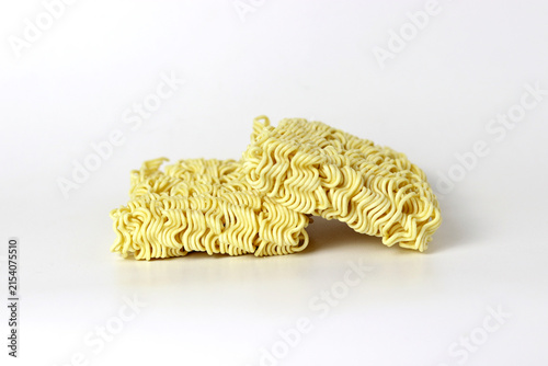 Uncooked instant noodles stacked on a clean white background