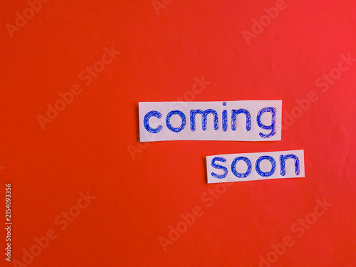 Coming soon message with hand-drawn text on red background