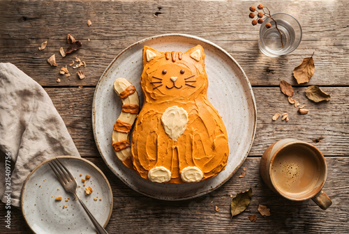 Cute Orange Cat Shaped Cake on Rustic Wood Table