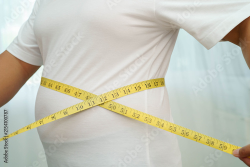 Foto Asian woman with fat belly big size overweight and obesity with measure tape
