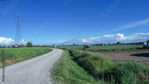 Quadro su tela Intensive agriculture in Po Valley Italy uses sprinklers to irrigate crops durin