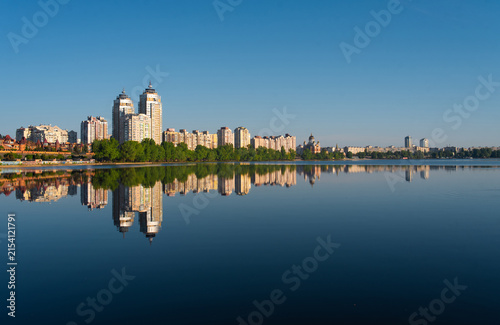 Kyiv Obolon waterfront skyline reflected in calm lake water