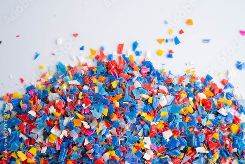 Fotografie Plastic colorful pieces recycling shredded for industrial use.