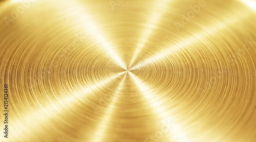 Circular brushed gold metallic surface texture background with radial light reflection