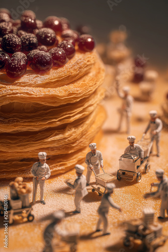 Pancake stack with cherry sauce and miniature people figures