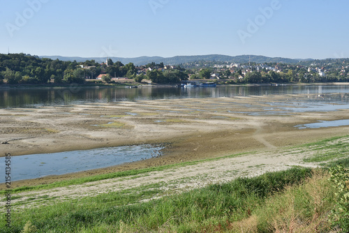 Low river water level on the Danube with suspended cargo ship navigation due to severe hydrological drought and climate change