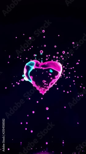 AI generated 4k vertical video of liquid heart splashing under glowing neon lighting.