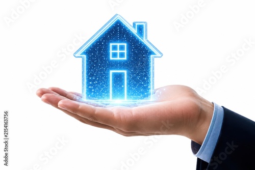 Business person holding a glowing blue house icon in their hand