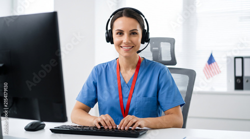 Smiling Nurse Wearing Headset Working in Telehealth Call Center for Patient Support and Medical Consultation