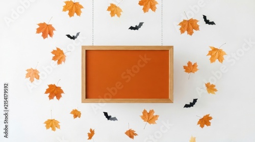 White frame surrounded by autumn leaves on white background