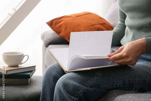 Woman relaxing on a sofa, t...