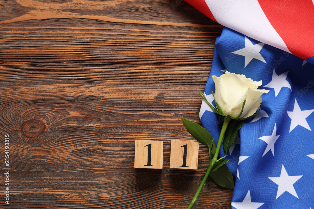 Obraz premium Veterans day with american flag, white rose, and number 11 on rustic wooden background