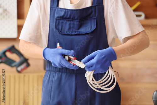 Electrician in blue uniform...