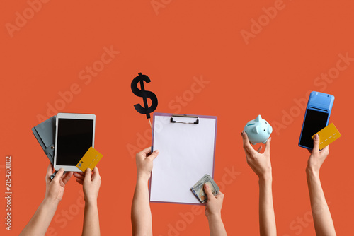 Female hands with credit cards, tablet computer, piggy bank and clipboard on ...
