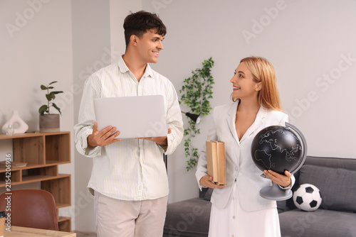 Teachers with laptop in school office