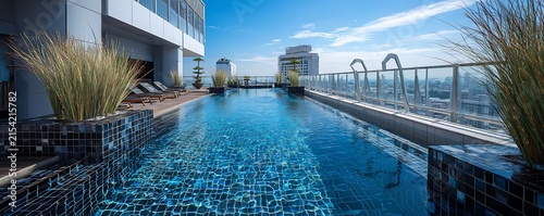 swimming pool at the bank of the luxurious beach glass platted with sierra blue water abstract backgroiund 
