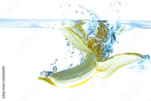 Pealed banana splashing into water