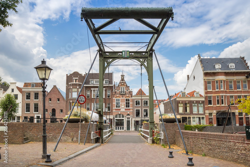Historic iron mouter bridge over a scenic traditional canal in Delfshaven, Rotterdam, Netherlands
