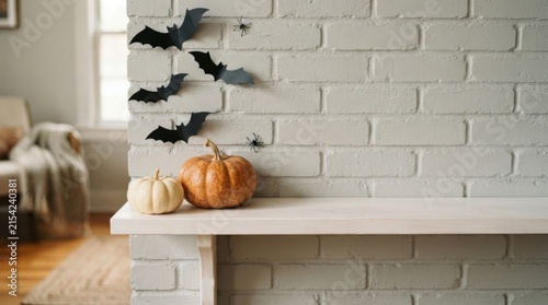 Minimalist grey brick fireplace shelf with pumpkins and bats