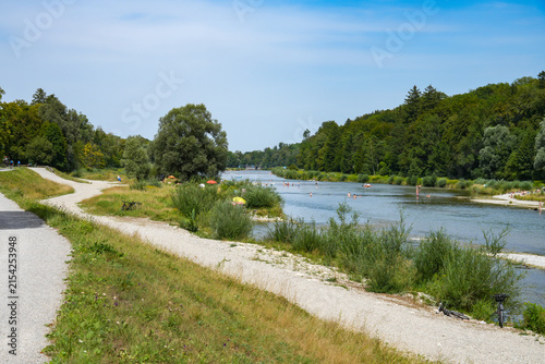 A section of the restored Isar River in southern Munich, in the Isar floodplains near Thalkirchen/Flaucher, featuring the typical gravel banks and accompanying walking trails.