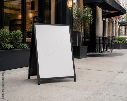 Blank Freestanding Sidewalk Sign Outside Contemporary Cafe Blank Branding Mockup for Commercial Design and Advertising