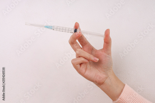 Fotografía Hand Holding Medical Syringe Between Fingers